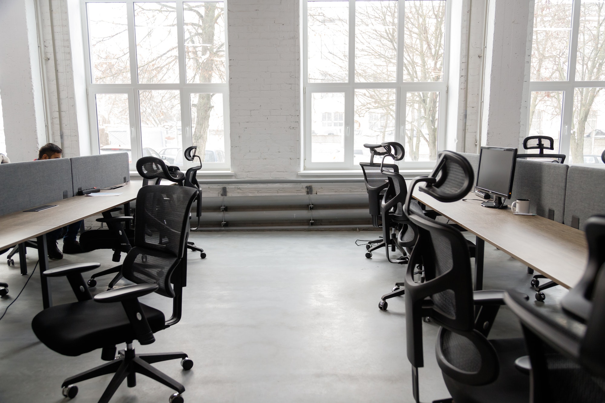 Interior of modern coworking space without people, containing tables and chairs