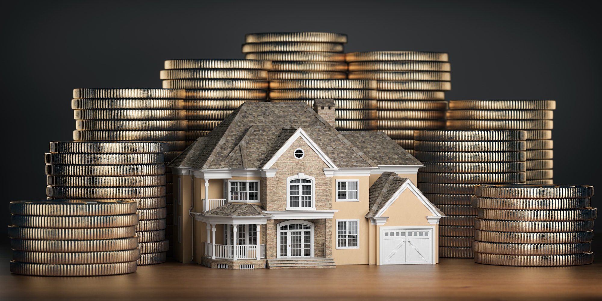 Real estate investments and mortgage concept. House and stack of coins.