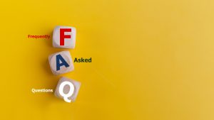 FAQ concept on wooden cubes and word FAQ on a yellow background.