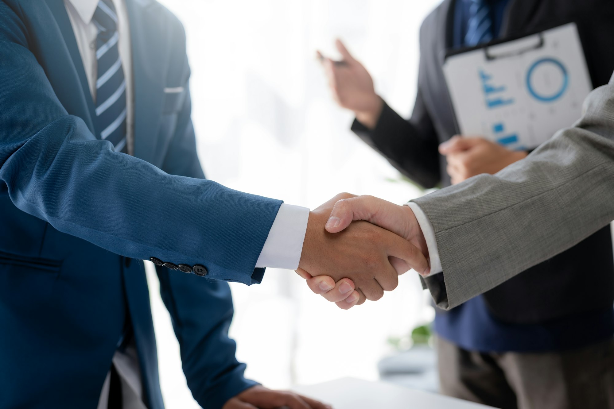 Successful co-investment. Business people handshake represent successful negotiations.